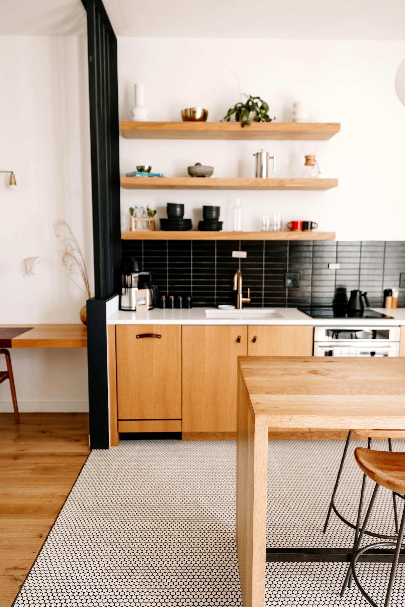 Sleek modern kitchen with minimalist wood elements and open shelving.